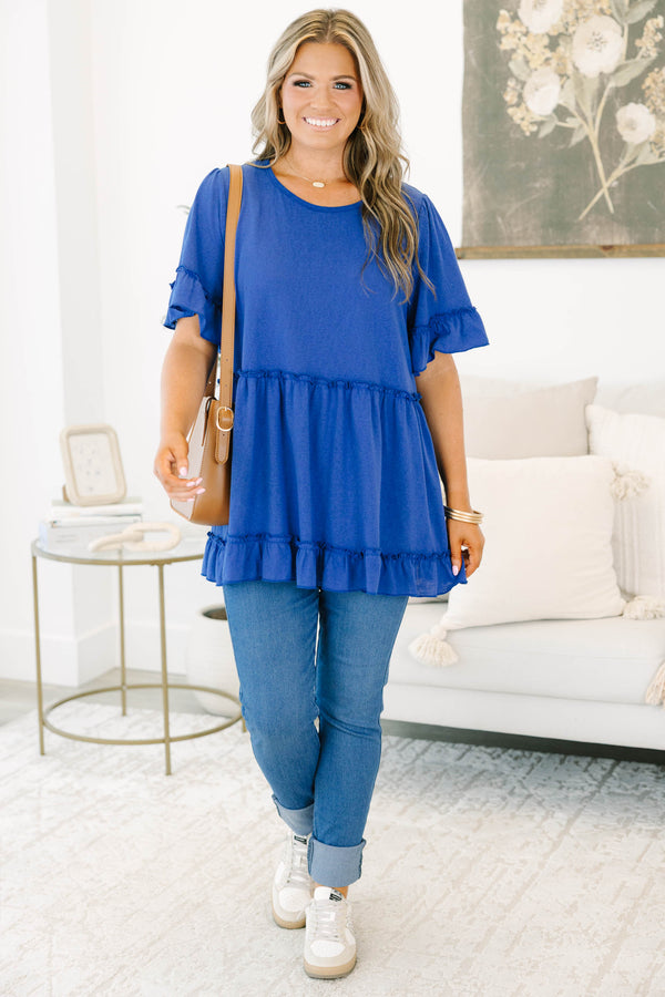 Plus size blue flowy top with ruffle sleeves and a tiered babydoll silhouette in a soft cotton blend