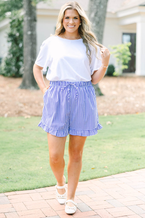 Plus Size dark blue and white gingham shorts with a ruffled hem and drawstring elastic waist.
