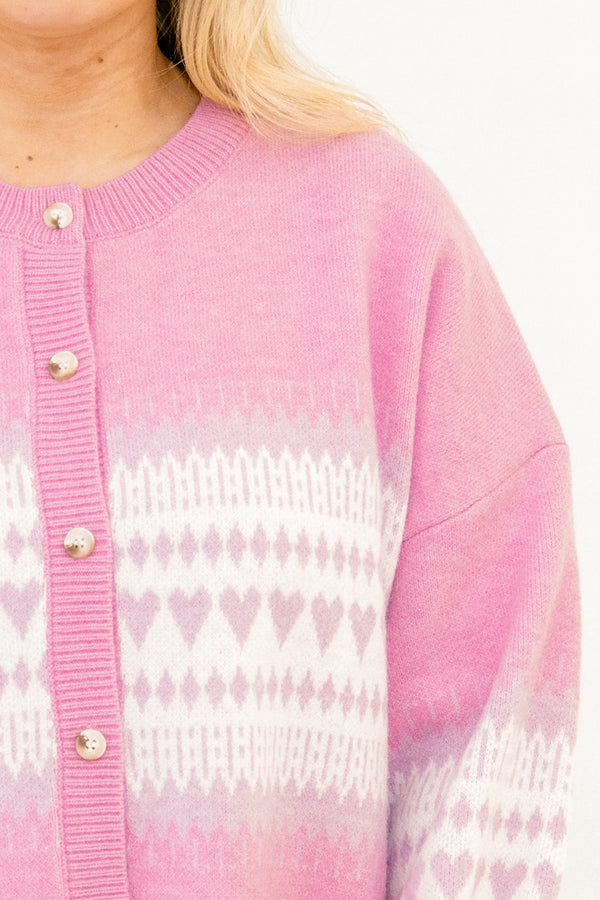 Chic Soul plus size clothing, light pink slouchy long sleeve cardigan with white and purple heart pattern across the middle and wooden button along the front