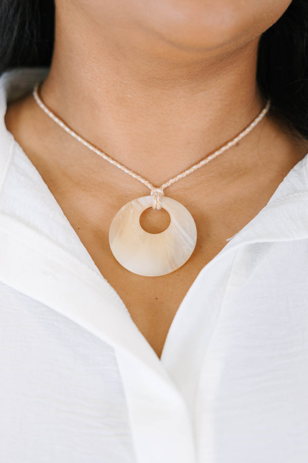 Plus Size natural marbled resin circle pendant on a tan braided cord necklace.