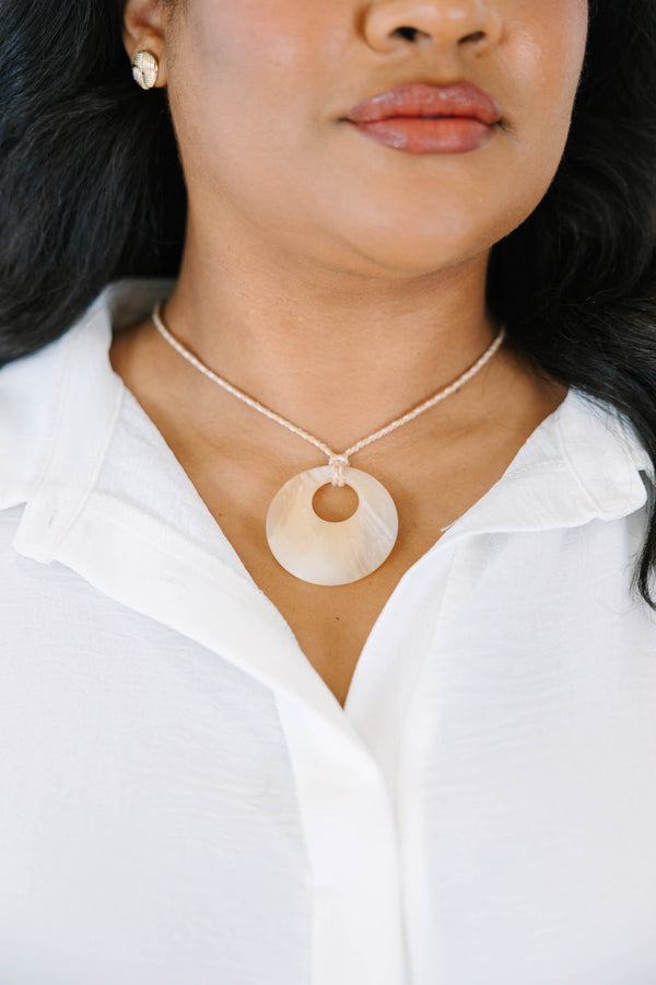 Plus Size natural marbled resin circle pendant on a tan braided cord necklace.