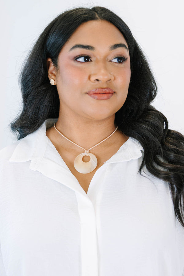 Plus Size natural marbled resin circle pendant on a tan braided cord necklace.