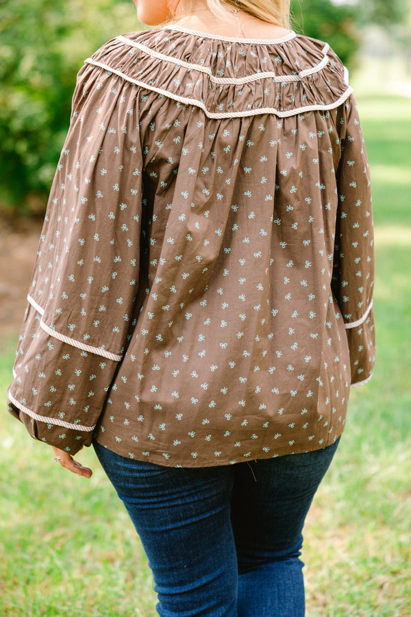 Chic Soul plus size clothing, brown top with long bubble sleeves and a baby blue bow pattern throughout with white stitching details on chest and sleeves 