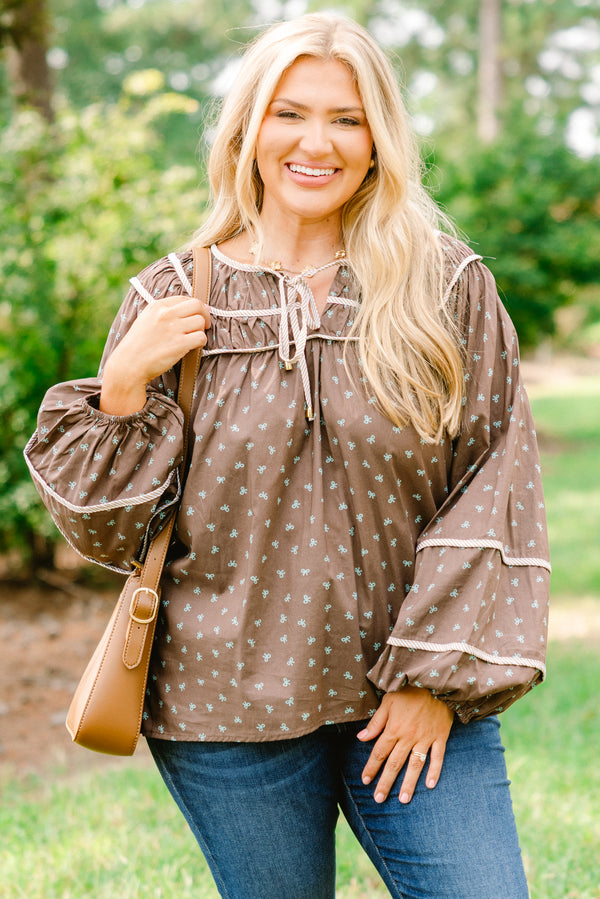 Chic Soul plus size clothing, brown top with long bubble sleeves and a baby blue bow pattern throughout with white stitching details on chest and sleeves 