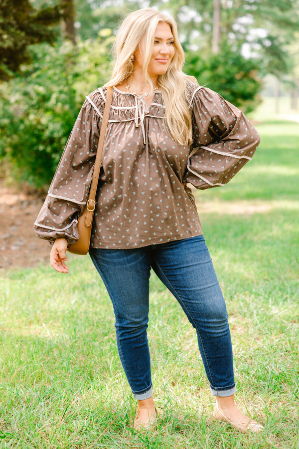 Chic Soul plus size clothing, brown top with long bubble sleeves and a baby blue bow pattern throughout with white stitching details on chest and sleeves 