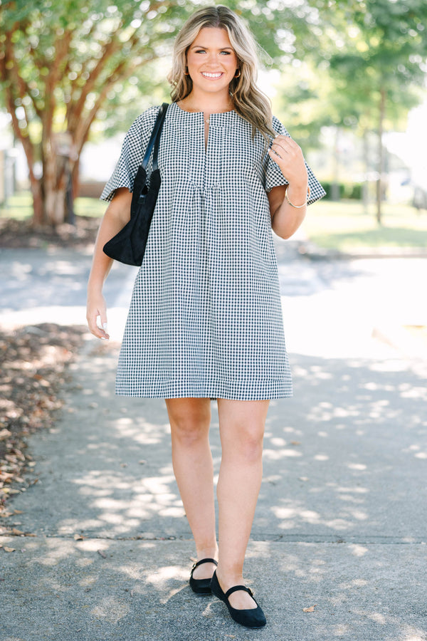Plus Size black and white gingham dress with a split v-neckline and short flutter sleeves.