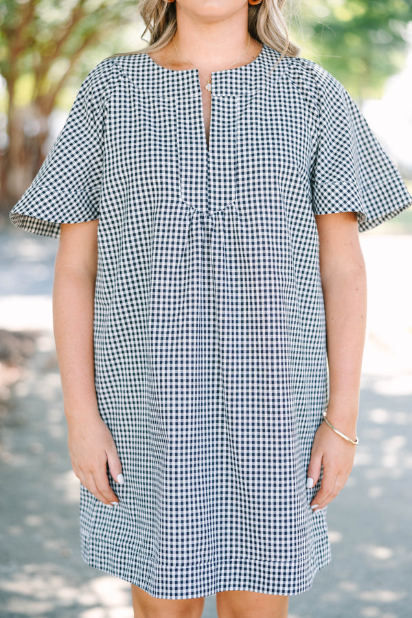 Plus Size black and white gingham dress with a split v-neckline and short flutter sleeves.