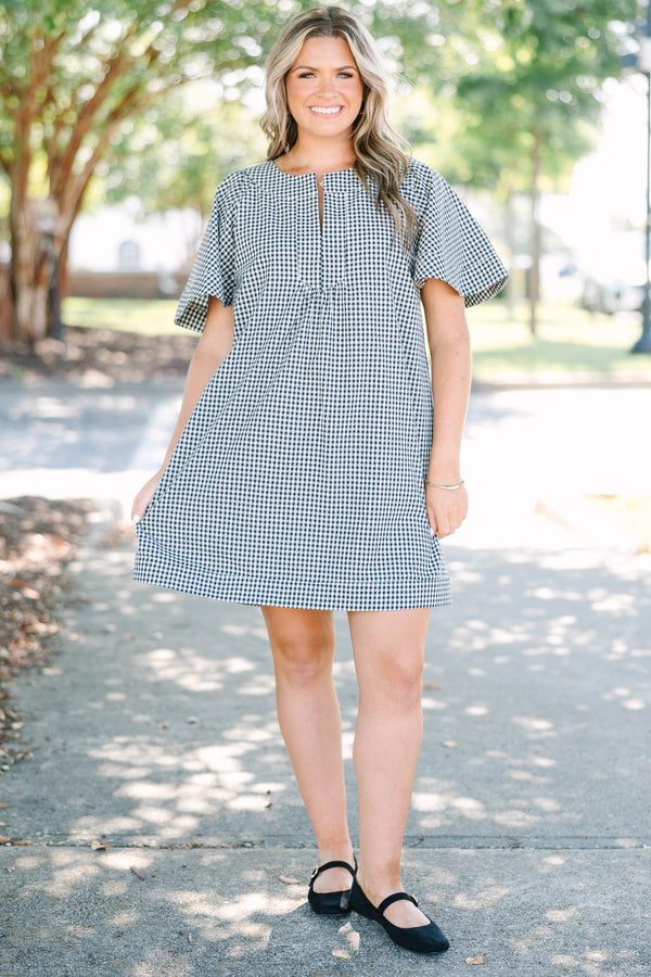 Plus Size black and white gingham dress with a split v-neckline and short flutter sleeves.
