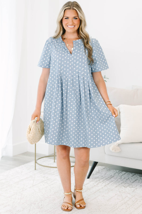 Plus Size blue polka dot dress with short puff sleeves, a V-neckline, and a flowy pleated skirt.