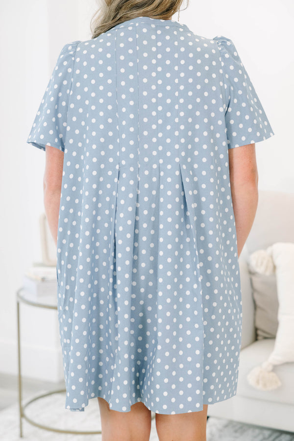 Plus Size blue polka dot dress with short puff sleeves, a V-neckline, and a flowy pleated skirt.