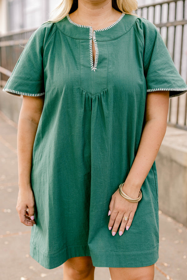 Chic Soul plus size clothing, dark green short bell sleeve knee length flowy dress with subtle v neckline and white stitching detailing around the sleeves and collar 
