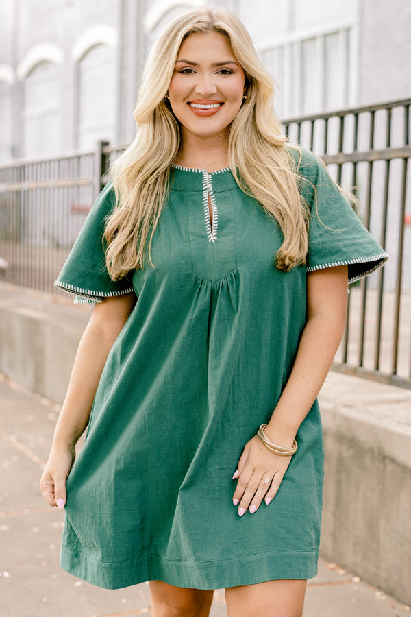 Chic Soul plus size clothing, dark green short bell sleeve knee length flowy dress with subtle v neckline and white stitching detailing around the sleeves and collar 