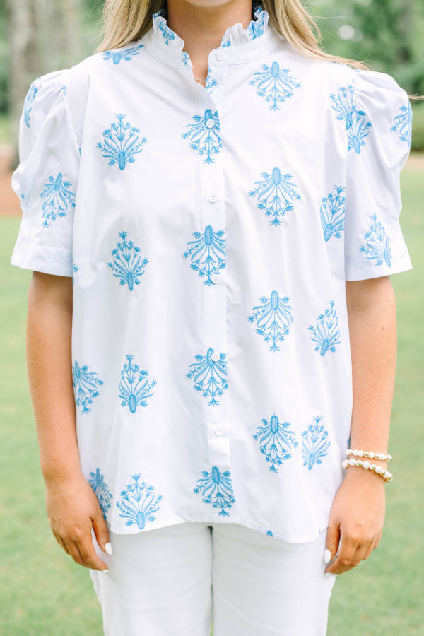 Plus Size white button-down top with blue floral embroidery, ruffled collar, and puff sleeves.
