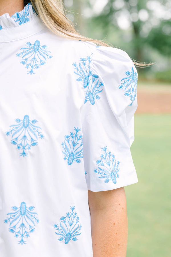 Plus Size white button-down top with blue floral embroidery, ruffled collar, and puff sleeves.