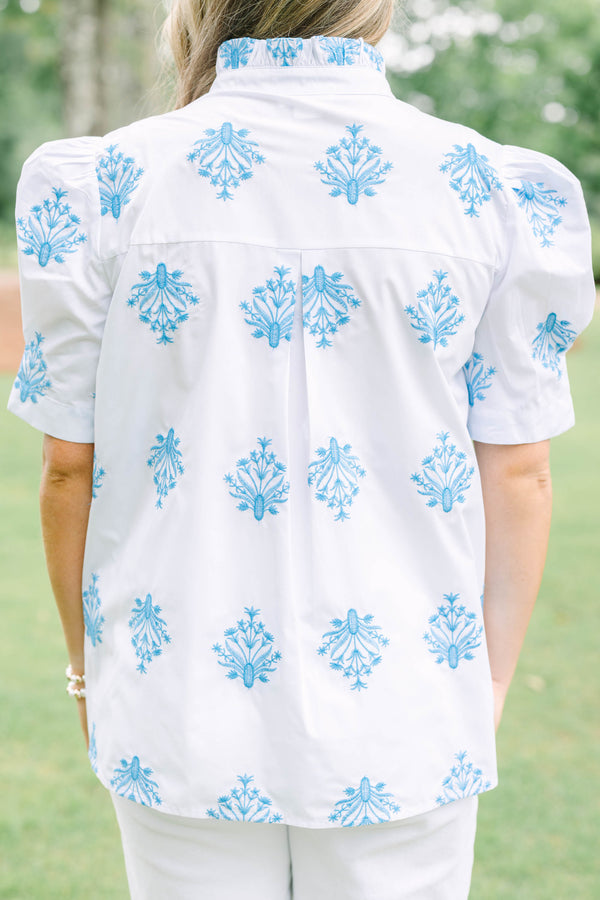 Plus Size white button-down top with blue floral embroidery, ruffled collar, and puff sleeves.