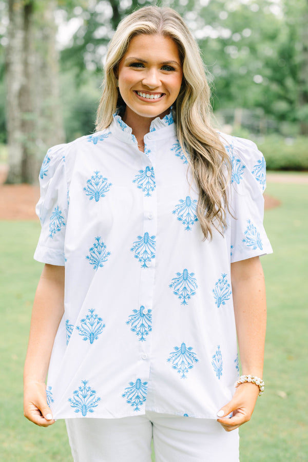Plus Size white button-down top with blue floral embroidery, ruffled collar, and puff sleeves.