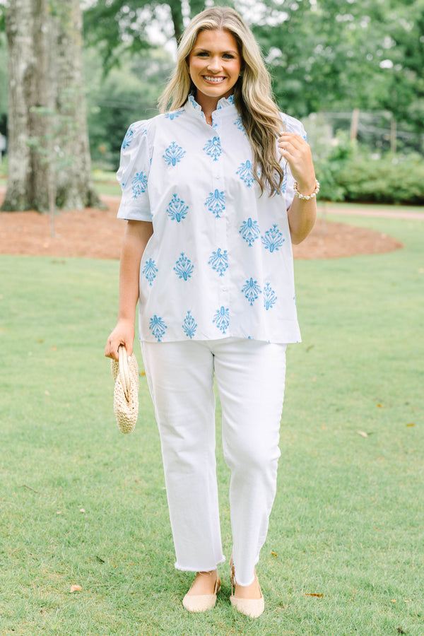 Plus Size white button-down top with blue floral embroidery, ruffled collar, and puff sleeves.