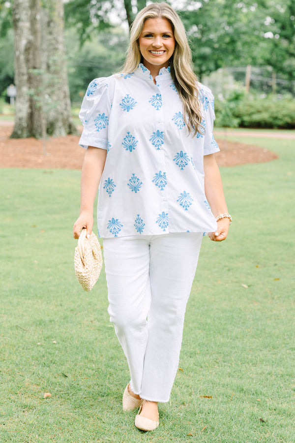 Plus Size white button-down top with blue floral embroidery, ruffled collar, and puff sleeves.