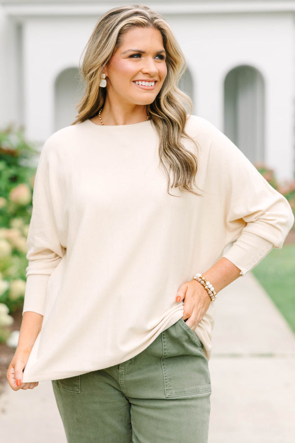 Plus Size beige relaxed fit knit sweater with a round neckline and button-cuffed long sleeves.
