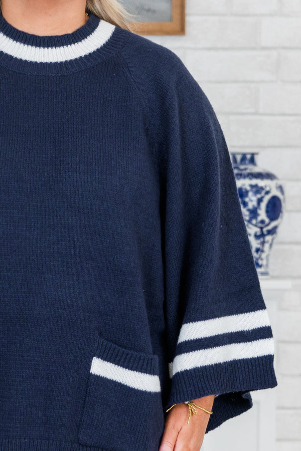 Chic Soul plus size clothing, long-sleeve navy blue knit top with a mock-neckline and a color block white striped pattern along the sleeves and neckline with two pockets along the bottom of the top