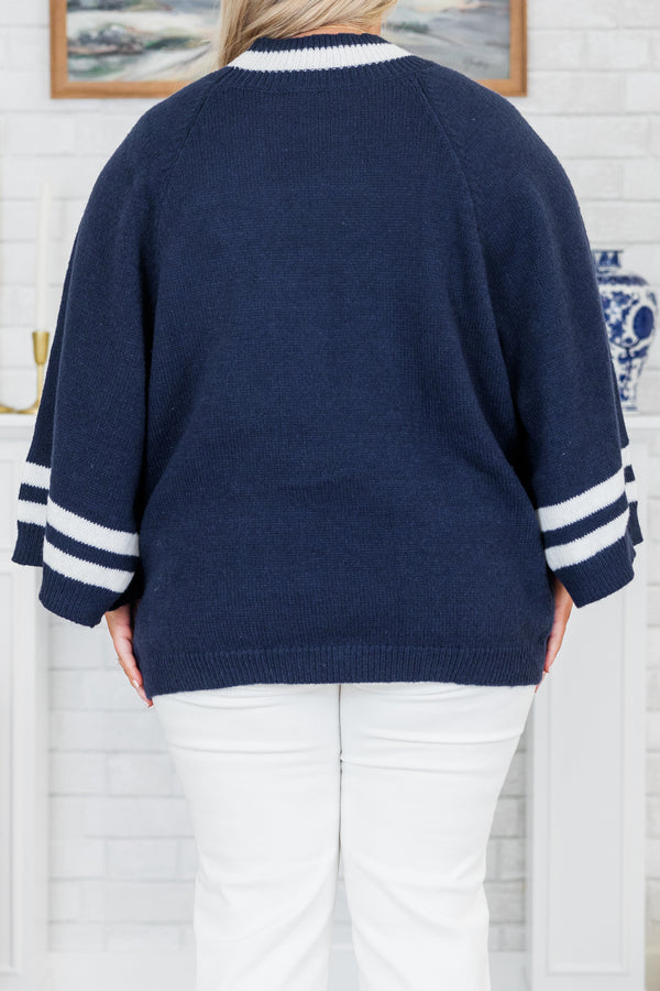 Chic Soul plus size clothing, long-sleeve navy blue knit top with a mock-neckline and a color block white striped pattern along the sleeves and neckline with two pockets along the bottom of the top