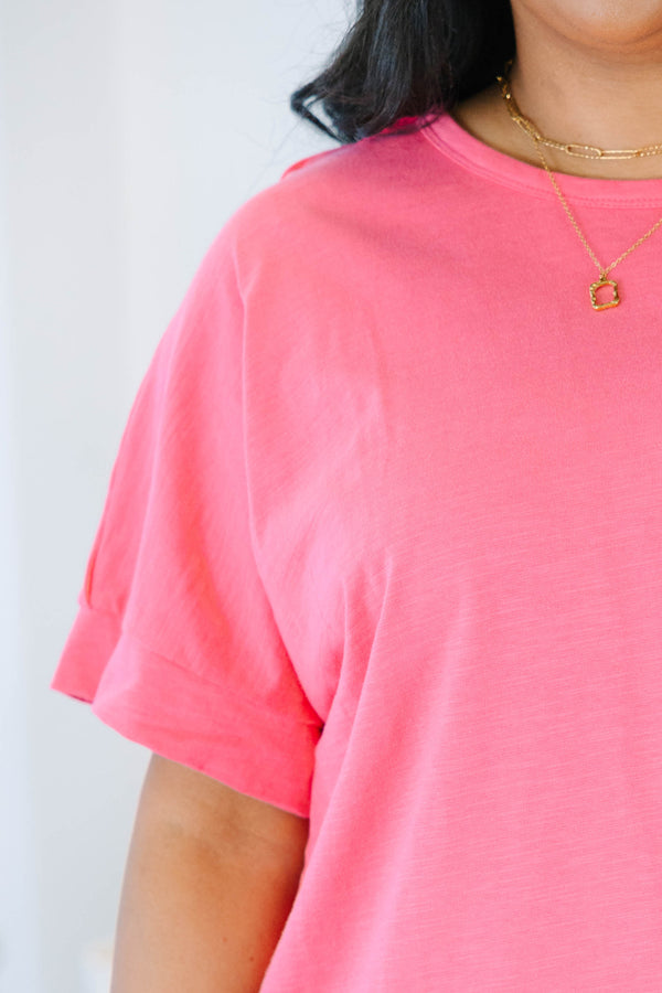 Plus Size pink short sleeve pocket tee with a crew neck and relaxed fit, paired with black shorts.