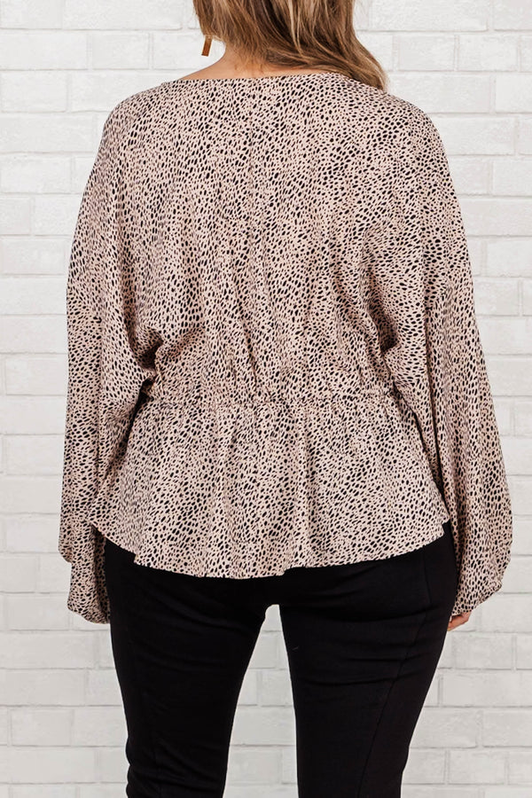 Chic Soul Plus size clothing, tan top with v-neck, gathered waist, long flowy sleeves and black spotted print.