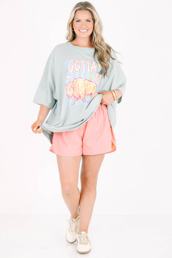 Plus Size light sage boyfriend tee with a buffalo graphic and pink athletic shorts.