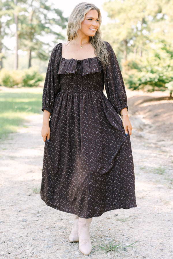 Plus size brown floral midi dress with a smocked waist, ruffled neckline, and flowy long sleeves.