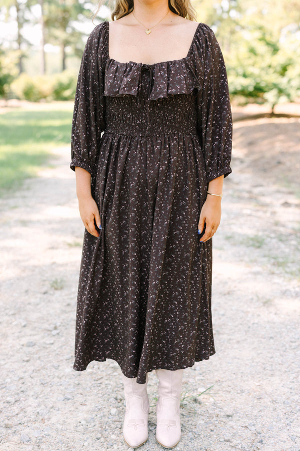 Plus size brown floral midi dress with a smocked waist, ruffled neckline, and flowy long sleeves.