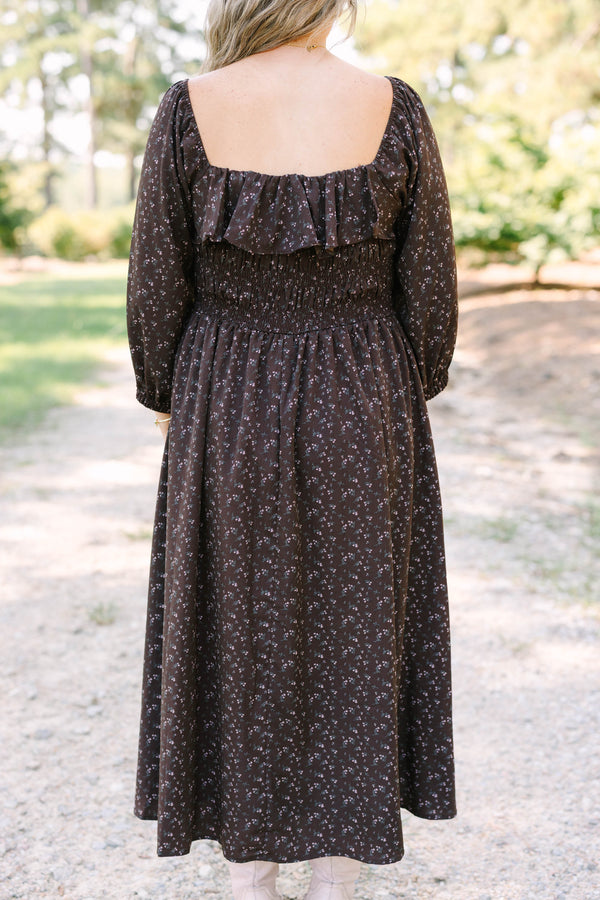 Plus size brown floral midi dress with a smocked waist, ruffled neckline, and flowy long sleeves.