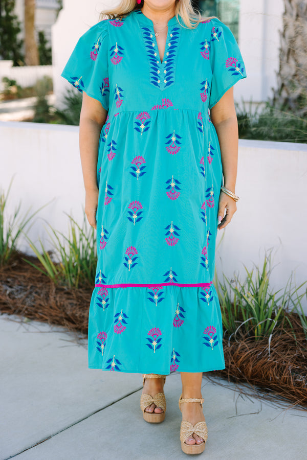 Chic Soul plus size clothing, turquoise maxi dress with short sleeves and a slight v-neckline as well as a floral block pattern throughout and pink stitching details on the bottom tier of the dress 