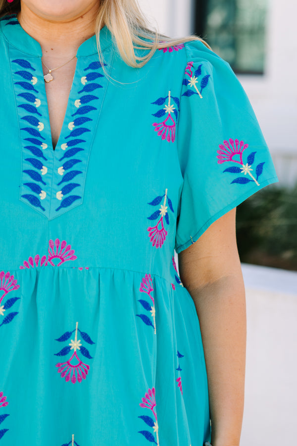 Chic Soul plus size clothing, turquoise maxi dress with short sleeves and a slight v-neckline as well as a floral block pattern throughout and pink stitching details on the bottom tier of the dress 