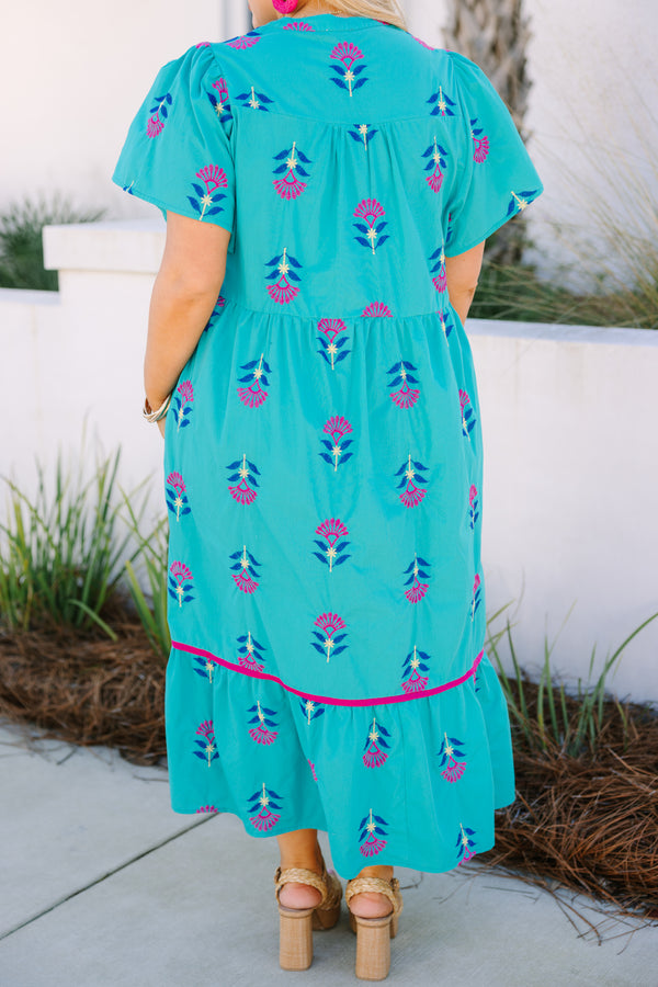 Chic Soul plus size clothing, turquoise maxi dress with short sleeves and a slight v-neckline as well as a floral block pattern throughout and pink stitching details on the bottom tier of the dress 