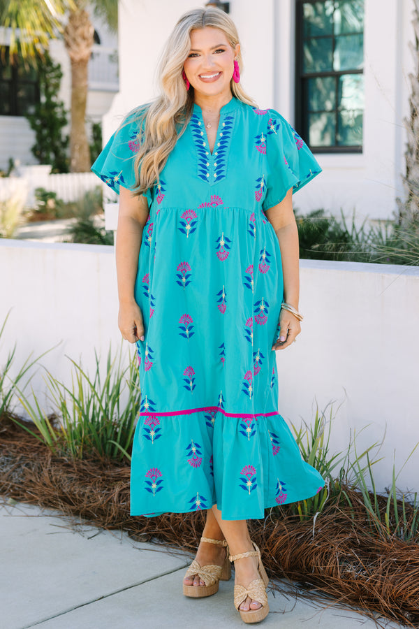 Chic Soul plus size clothing, turquoise maxi dress with short sleeves and a slight v-neckline as well as a floral block pattern throughout and pink stitching details on the bottom tier of the dress 
