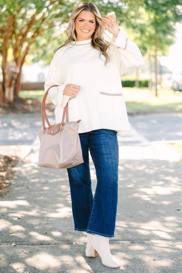 Plus Size ivory oversized sweater with a mock neck, wide sleeves, and tan stripe accents.