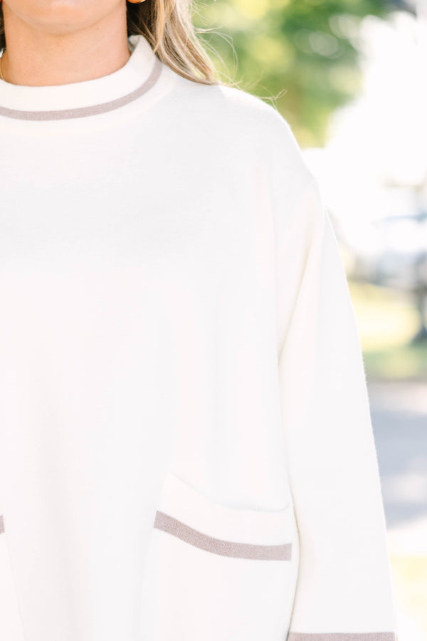 Plus Size ivory oversized sweater with a mock neck, wide sleeves, and tan stripe accents.