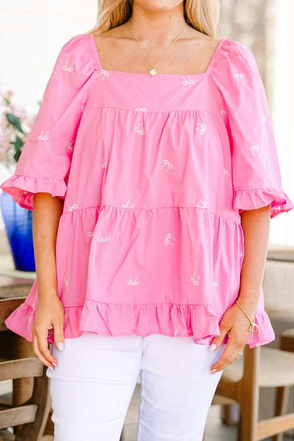 Plus Size pink babydoll top with white embroidered bows, square neckline, and ruffle trim.