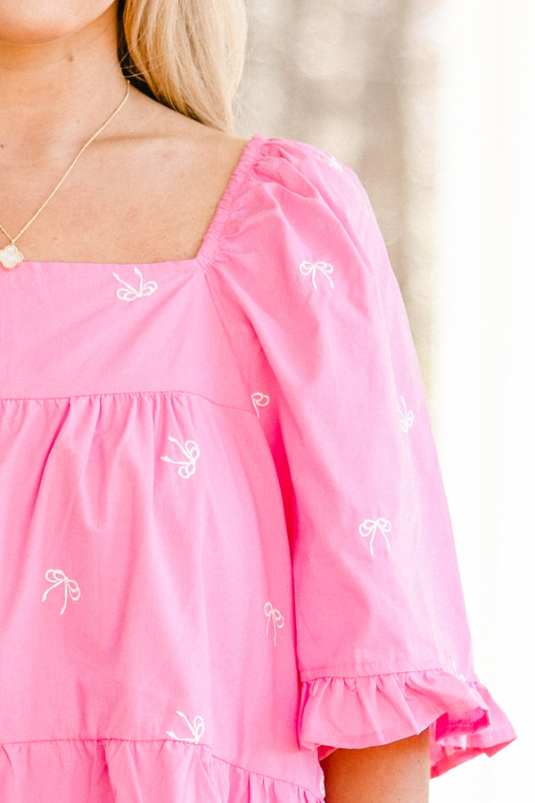 Plus Size pink babydoll top with white embroidered bows, square neckline, and ruffle trim.