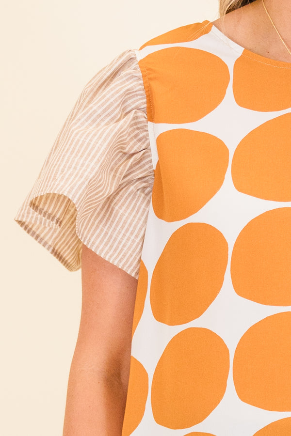 Chic Soul plus size clothing, taupe short sleeve top with orange and white polka dot print on front with taupe and white pinstripe pattern along sleeves and back