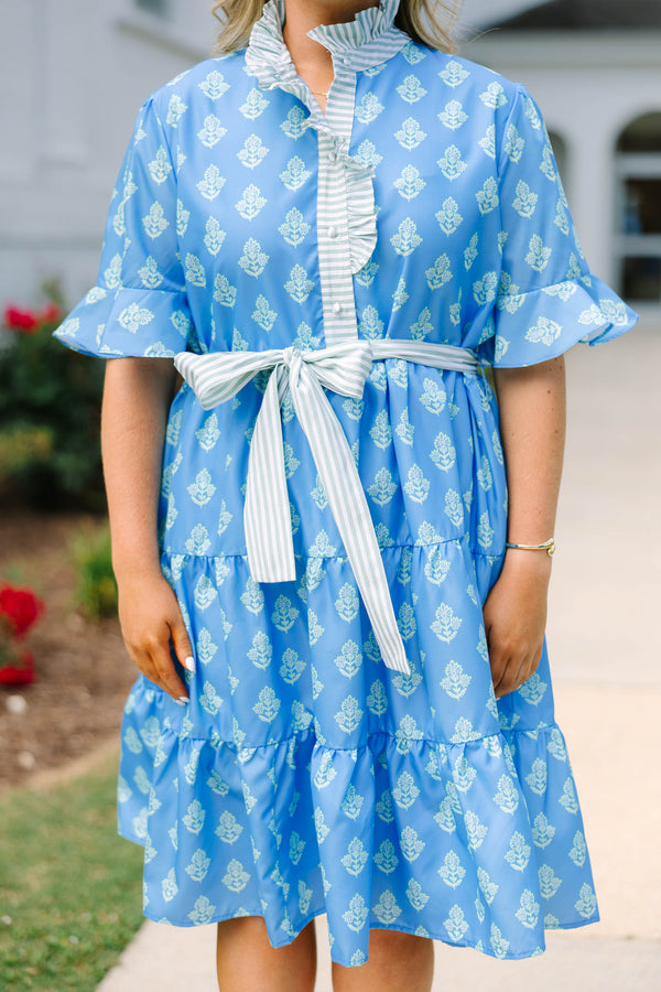 Plus Size blue tiered dress with white floral print, ruffled collar, and striped waist tie.