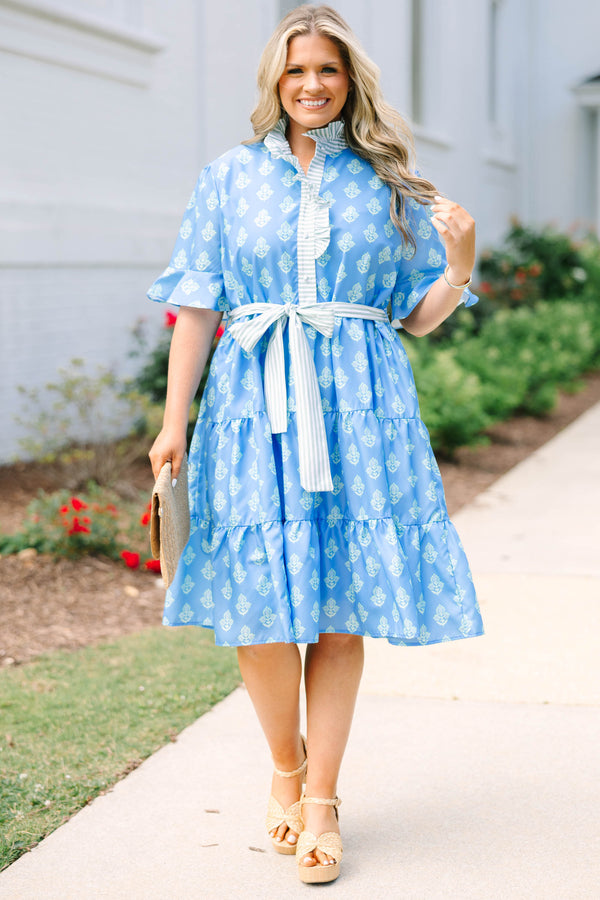 Plus Size blue tiered dress with white floral print, ruffled collar, and striped waist tie.