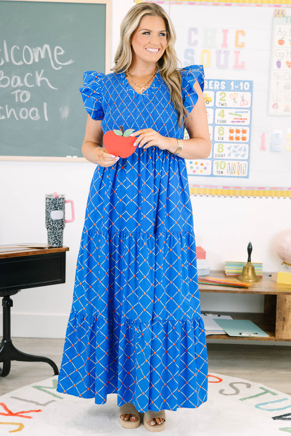 Plus Size blue maxi dress with an apple grid pattern, smocked bodice, and flutter sleeves.