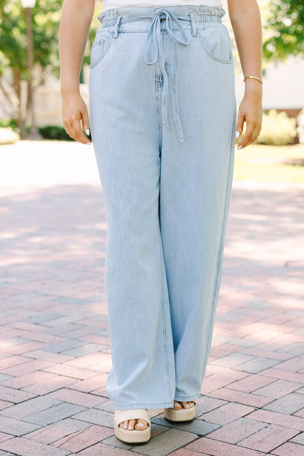 Plus Size light wash wide-leg jeans with an elastic drawstring waist and front pockets.