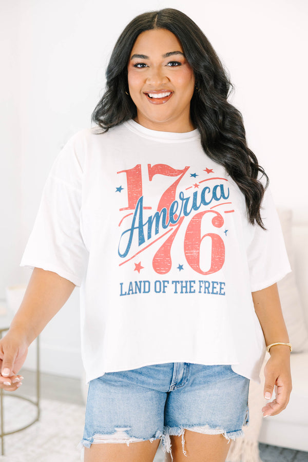 Plus Size white vintage wash graphic tee with 1776 America design and denim shorts.