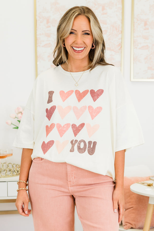 Chic Soul plus size clothing, short-sleeve ivory boyfriend tee with scoop-neckline and graphic art of several pink multi-colored hearts with graphic lettering stating 