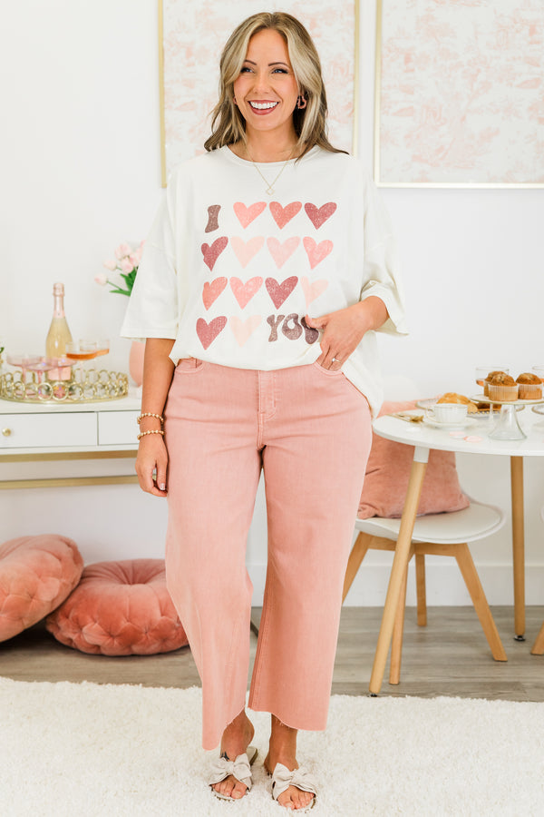 Chic Soul plus size clothing, short-sleeve ivory boyfriend tee with scoop-neckline and graphic art of several pink multi-colored hearts with graphic lettering stating 