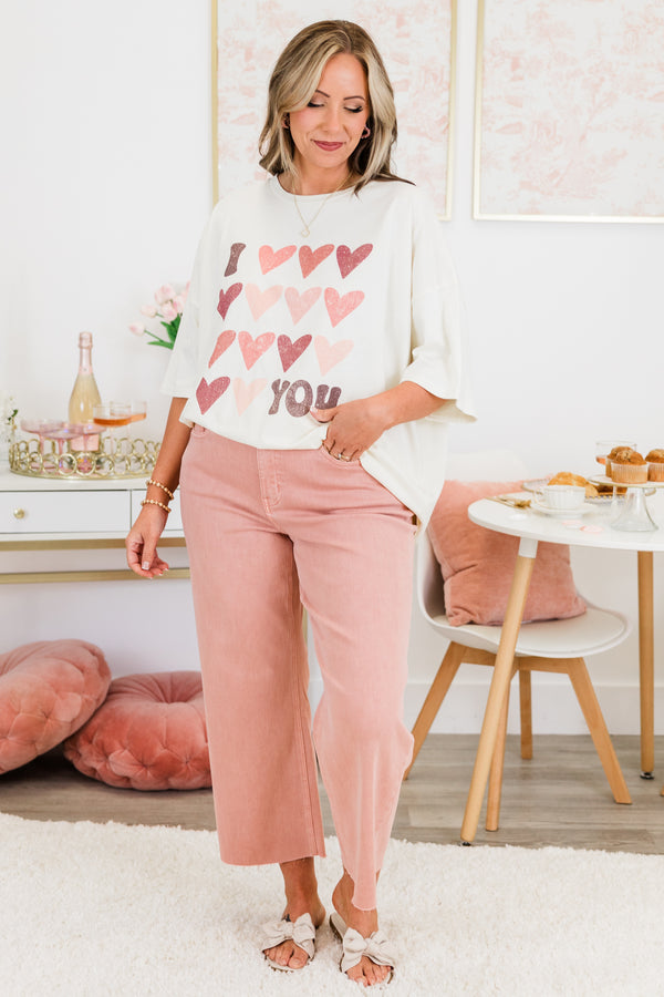 Chic Soul plus size clothing, short-sleeve ivory boyfriend tee with scoop-neckline and graphic art of several pink multi-colored hearts with graphic lettering stating 