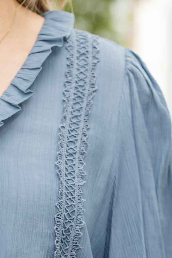 Chic Soul plus size clothing, denim blue long sleeve flowy top with v neckline and cuff sleeves with ruffle detail along neckline and front with eyelet details on front and sleeves