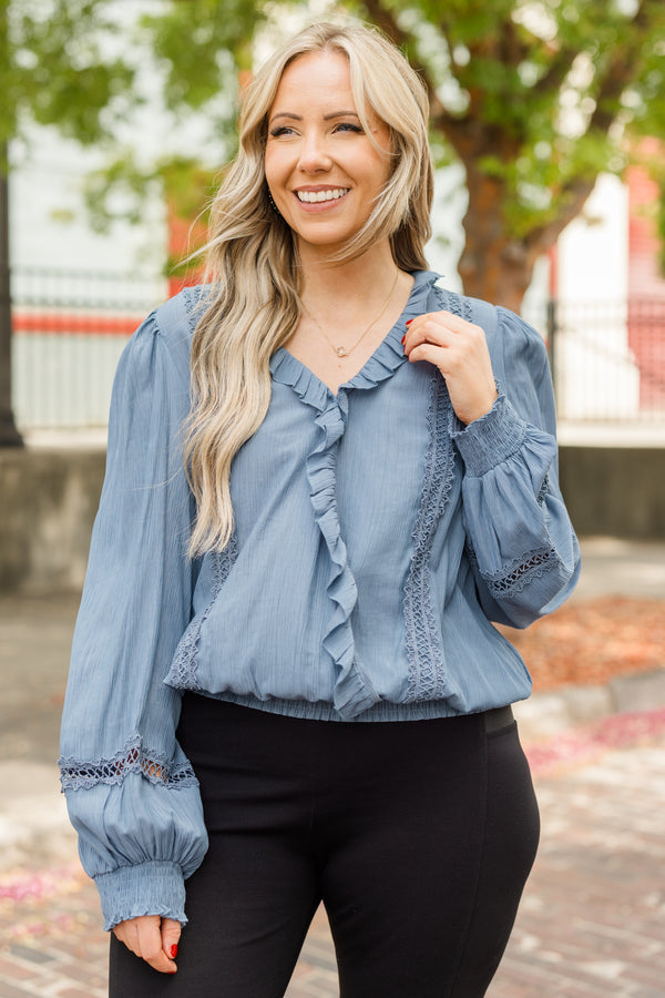 Chic Soul plus size clothing, denim blue long sleeve flowy top with v neckline and cuff sleeves with ruffle detail along neckline and front with eyelet details on front and sleeves